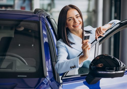 business-woman-choosing-a-car-in-a-car-showroom-scaled.jpg